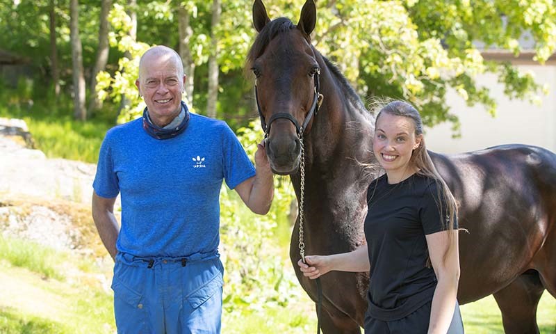 Frode Hamre sammen med Anne Bislingen Kristiansen fra Felleskjøpet foran noen av hestene på stallen.